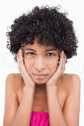 Teenager looking at the camera while thinking with her hands on