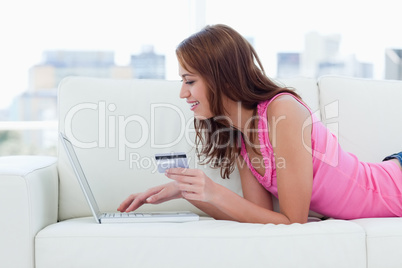 Young woman entering her credit card numbers on a website