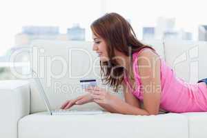 Young woman entering her credit card numbers on a website