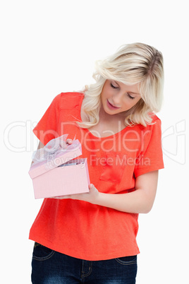 Fair-haired teenager opening her gift