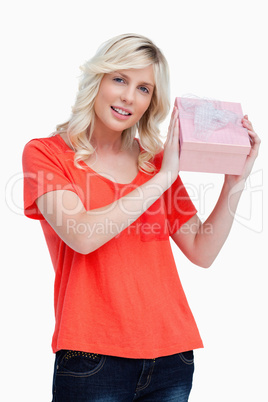 Young woman proudly holding her birthday gift