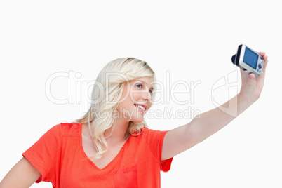 Smiling teenager photographing herself