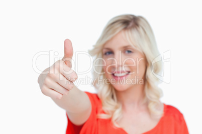 Thumbs up showed by young blonde woman