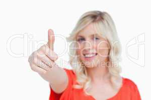 Thumbs up showed by young blonde woman