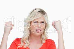 Young woman raising her fists showing her strength