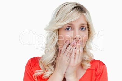 Surprised attractive woman placing her hands on her mouth