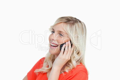 Woman laughing while talking on a cellphone