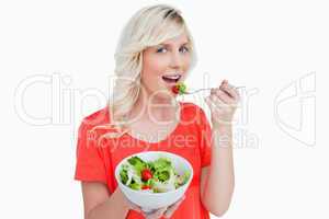 Vegetable salad eaten by a smiling fair-haired woman