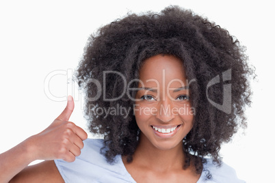 Young woman putting her thumbs up