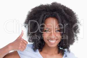 Young woman putting her thumbs up