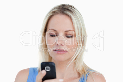 Serious blonde woman holding her cellphone