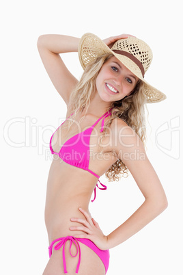 Attractive teenager posing with a hand on her hip and holding he