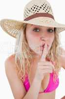 Young woman telling to be quiet with her finger on her mouth