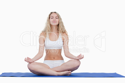Young attractive woman doing yoga in sportswear