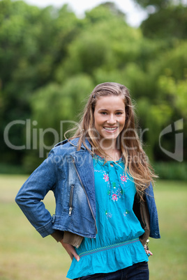 Smiling teenage girl standing in the countryside