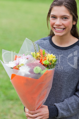 Young girl holding a bunch of flowers