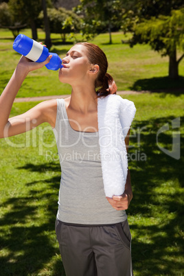 Woman drinking from a sports bottle