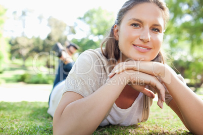 Smiling woman laying on the lawn