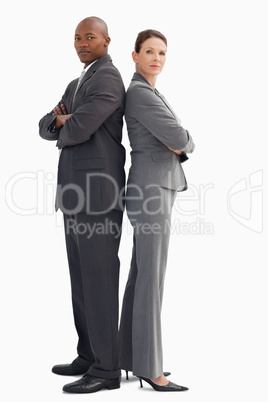 Business man and woman stand back to back