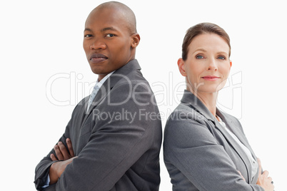 business people with hands crossed looking at camera
