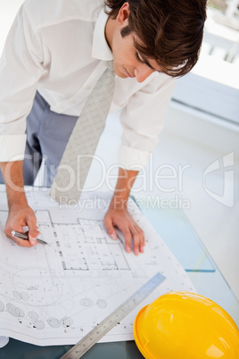 Man working hard on blueprints for work