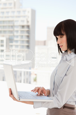 Woman at work using her laptop