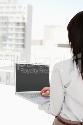 Woman with her back to the camera using her laptop