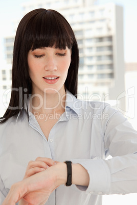 Close up of a woman checking the time on her watch