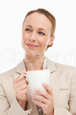 Woman in a suit holding a mug