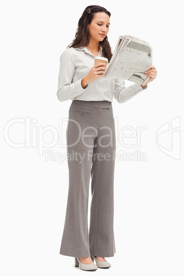 Employee reading the news with a coffee in the hand