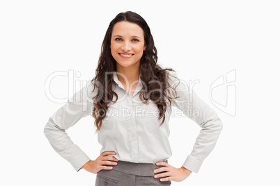 Portrait of a brunette businesswoman hands on hips smiling