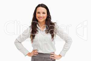 Portrait of a brunette businesswoman hands on hips smiling