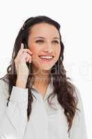 Pretty brunette smiling while phoning