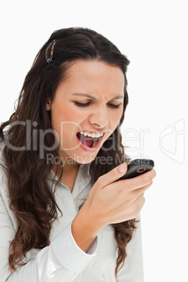 Brunette grimacing while reading her text message