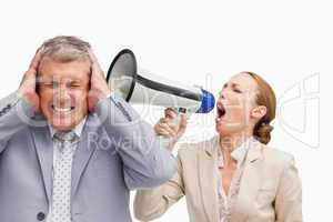 Businesswoman screaming with a megaphone after her colleague