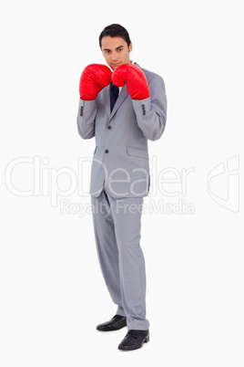 Man in a suit wearing boxing gloves