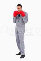 Man in a suit wearing boxing gloves