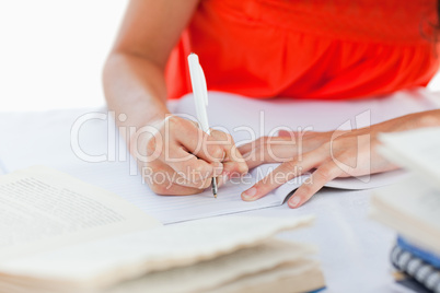 Close-up of a pen using by a student to do her homework