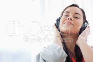 A peaceful woman listening to music on her headphones