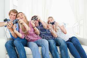 Friends enjoying video games as they all lean to the side