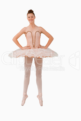 Smiling ballerina standing on her tiptoes