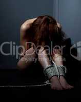 scared naked woman bind with rope in corner