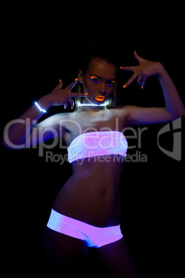 sexy girl with glow make-up in ultraviolet light