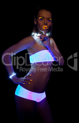 Disco sexy girl with glow make-up silence sign