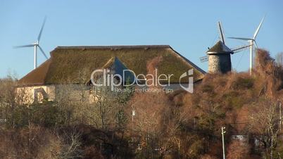 Cape cod thatched roof building, wind mills & turbines