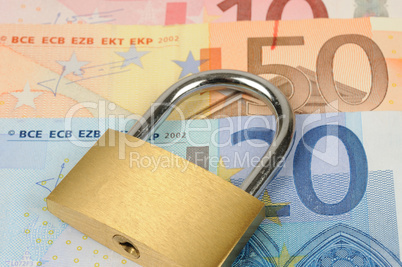 close up of a padlock on Euro banknote