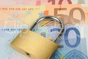 close up of a padlock on Euro banknote