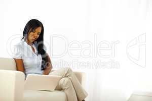 Black young woman browsing on laptop