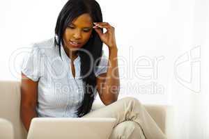 Pretty young woman browsing on laptop