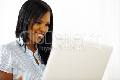 Cute young woman working on laptop